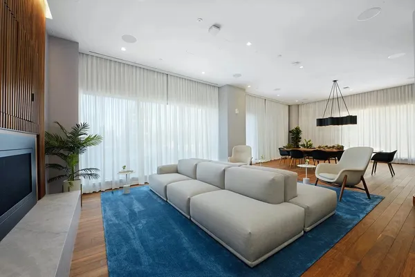 a living room with furniture and wooden floor