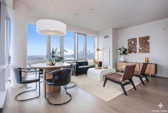 a living room with furniture a rug and a chandelier