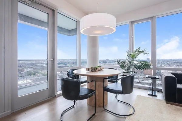 a view of a dining room with furniture window and wooden floor
