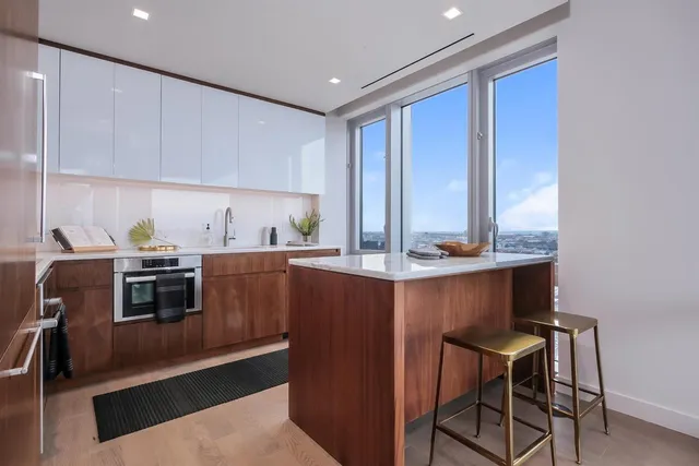 a kitchen with a sink cabinets and window