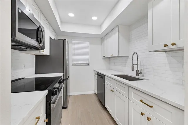 a kitchen that has a sink and a stove in it