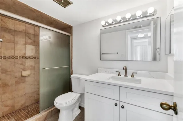 a bathroom with a sink toilet and shower
