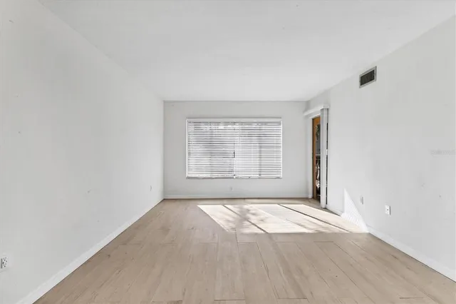 a view of an empty room with a window