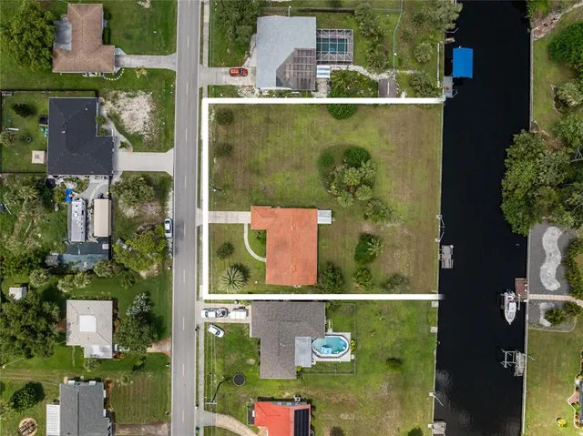 an aerial view of a residential houses with outdoor space