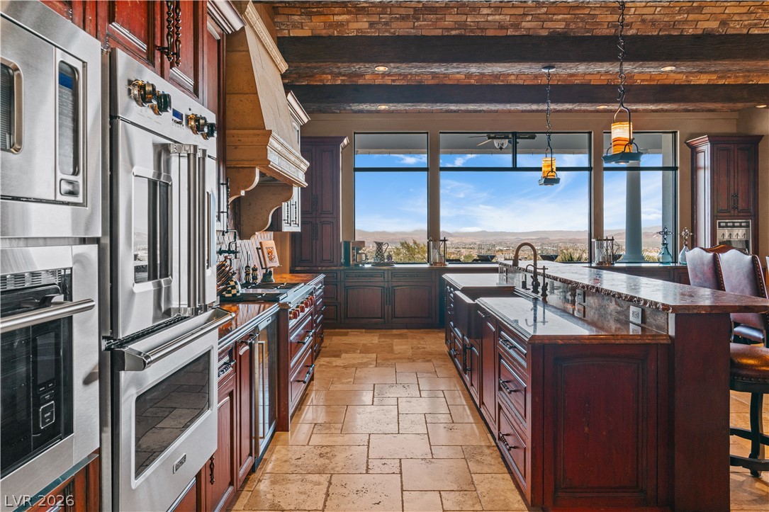1123 Christian Road Henderson, NV 89002 - Photo 18 of 94 An impressive kitchen with stainless steel appliances, rich wood cabinetry, and a vast city and mountain view.