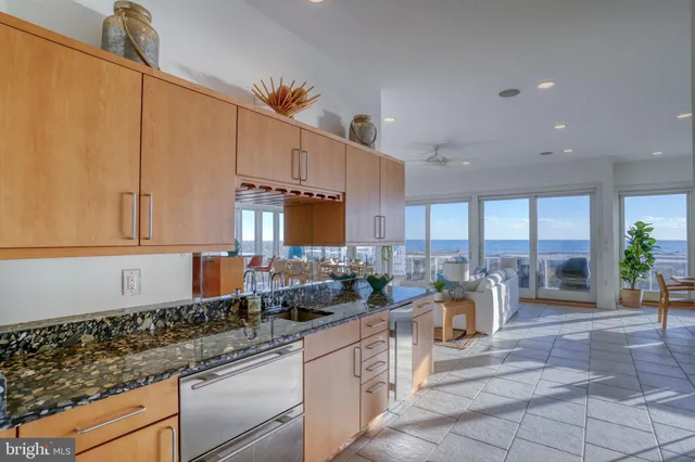 a spacious bedroom with a balcony a bed a couch and dresser