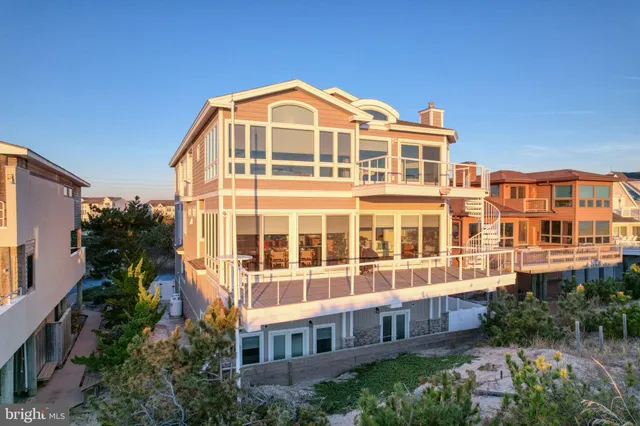 a living room with fireplace furniture and floor to ceiling windows