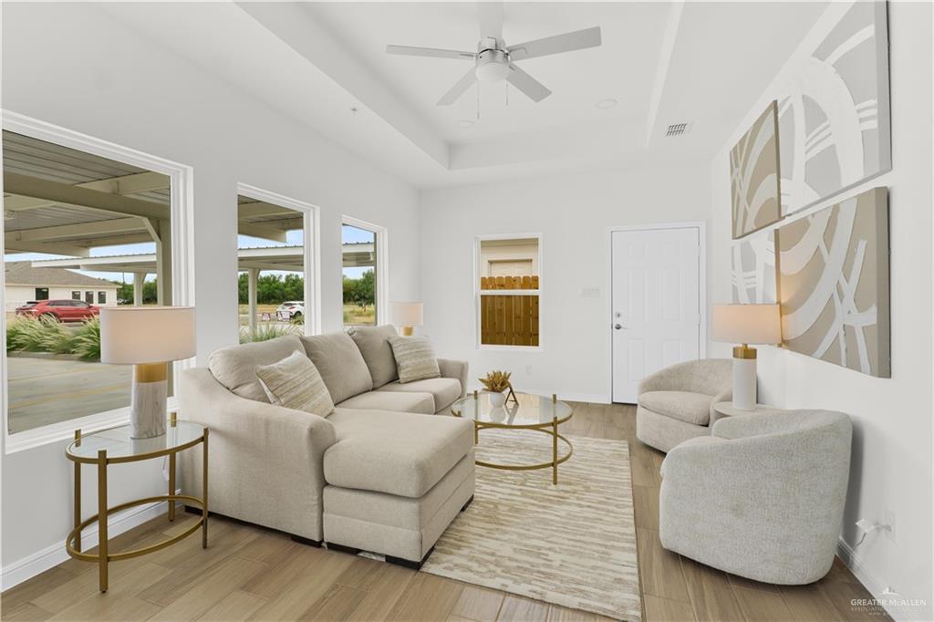 5323 Vision Street Rio Grande City, TX 78582 - Photo 13 of 16 Living area featuring a raised ceiling, wood finished floors, and ceiling fan