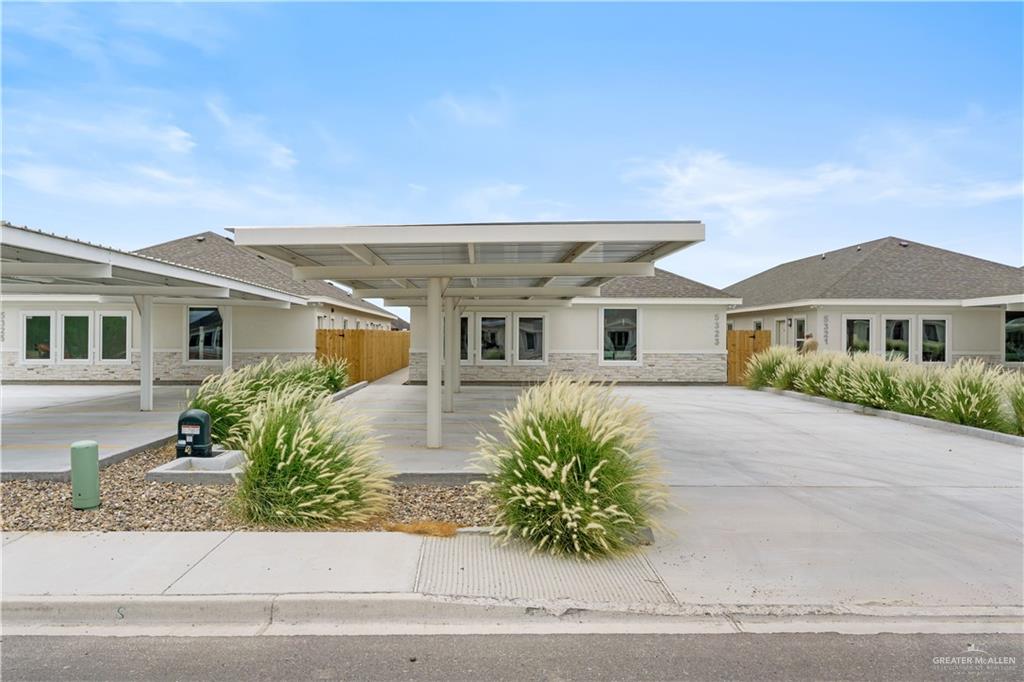 5323 Vision Street Rio Grande City, TX 78582 - Photo 2 of 16 View of front of home with stone siding, stucco siding, and a shingled roof