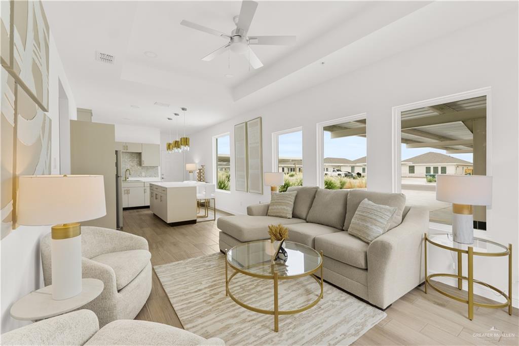 5323 Vision Street Rio Grande City, TX 78582 - Photo 9 of 16 Living room featuring a raised ceiling, light wood finished floors, and ceiling fan