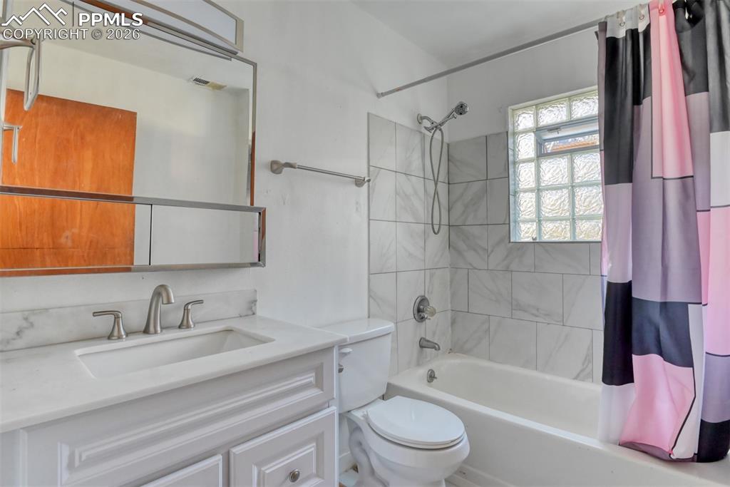 632 Santa Fe Street Colorado Springs, CO 80903 - Photo 19 of 24 a bathroom with a granite countertop sink toilet and shower