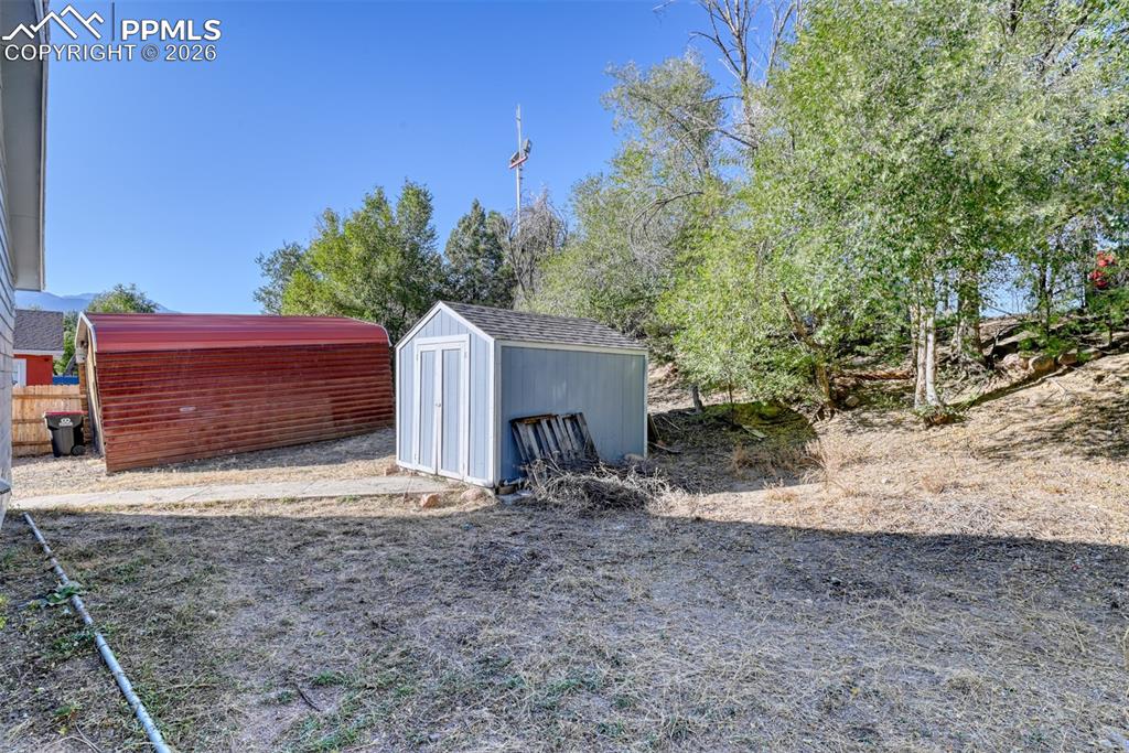 632 Santa Fe Street Colorado Springs, CO 80903 - Photo 23 of 24 a view of a barn in a yard with large tree