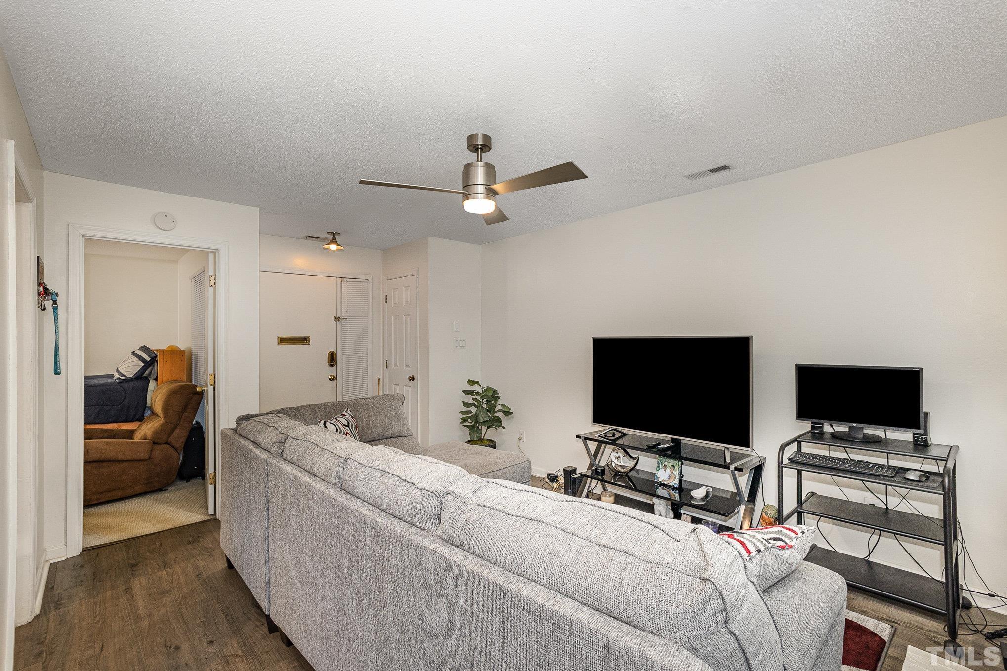 3219 Mill Run, Unit 175 Raleigh, NC 27612 - Photo 4 of 16 a living room with furniture and a flat screen tv