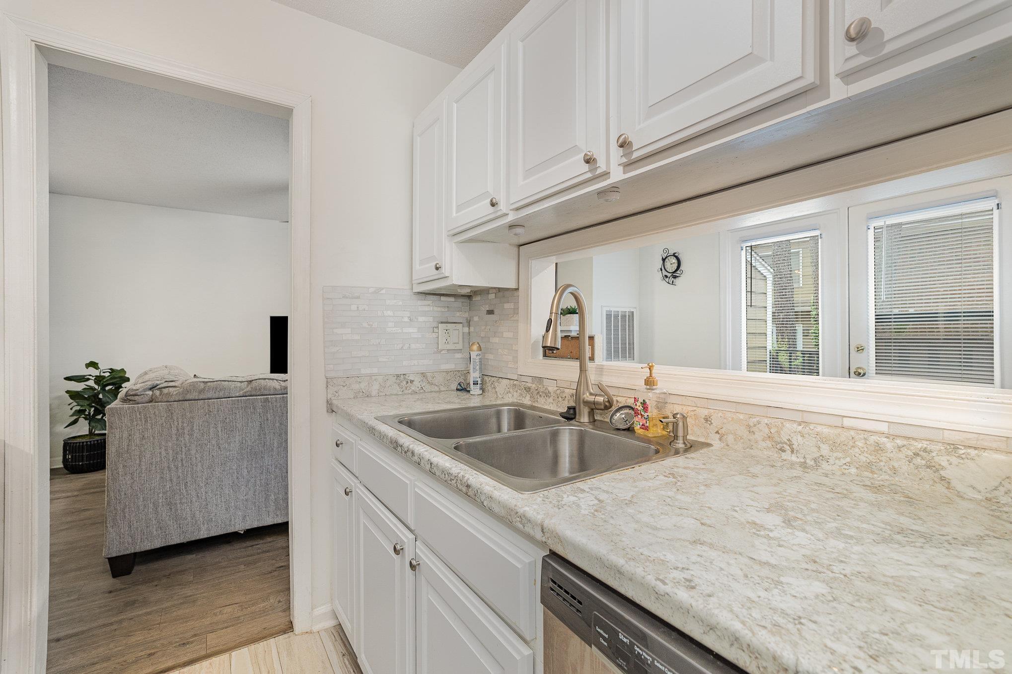 3219 Mill Run, Unit 175 Raleigh, NC 27612 - Photo 7 of 16 a kitchen with stainless steel appliances granite countertop a sink and cabinets
