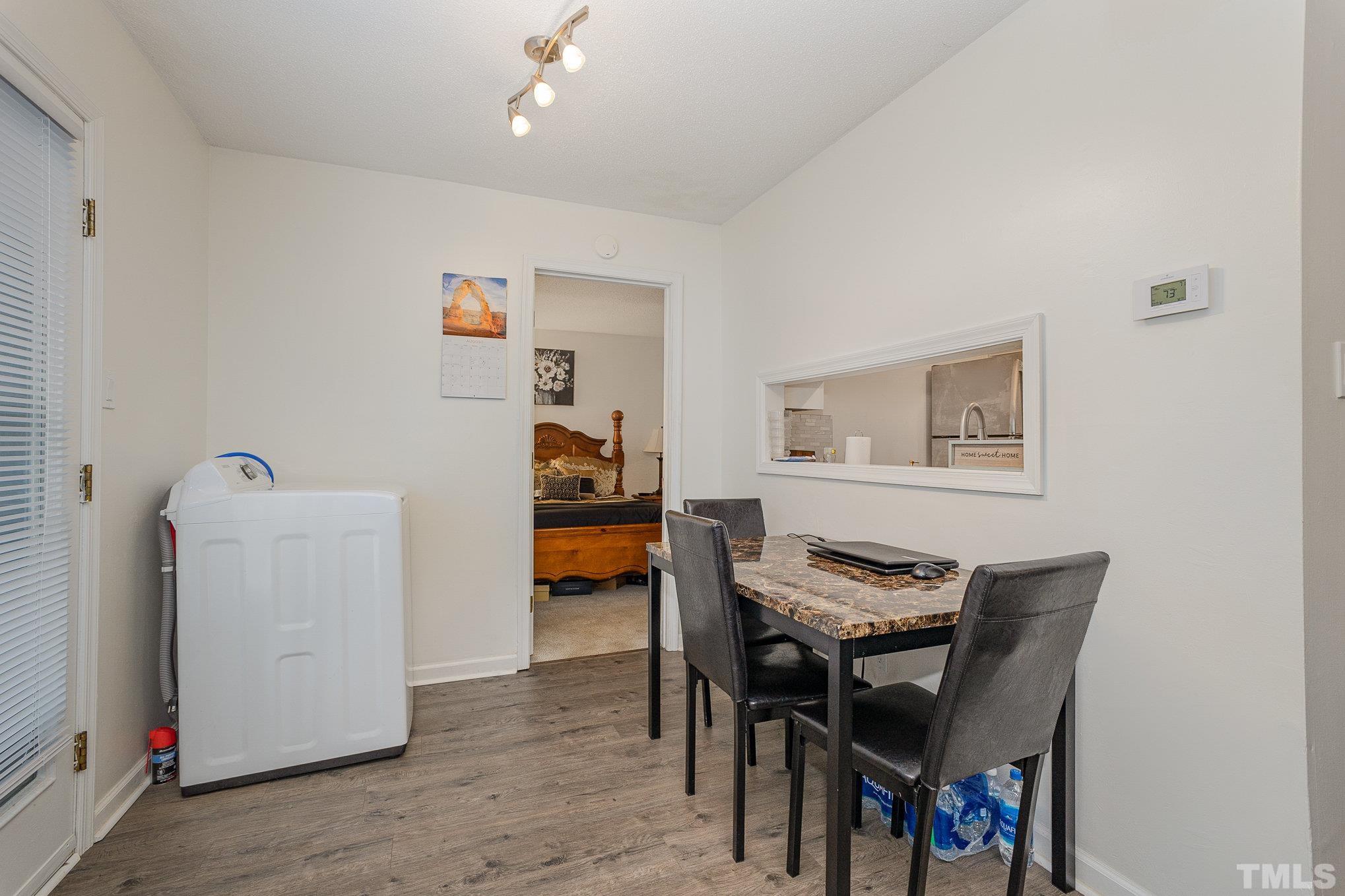 3219 Mill Run, Unit 175 Raleigh, NC 27612 - Photo 8 of 16 a view of a dining room with furniture and wooden floor