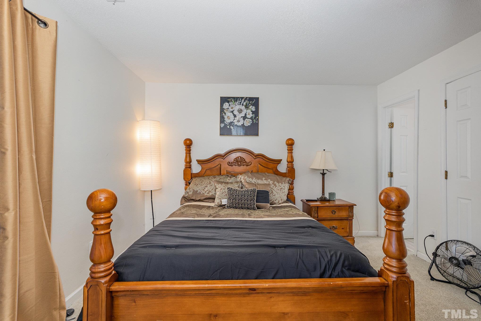 3219 Mill Run, Unit 175 Raleigh, NC 27612 - Photo 9 of 16 a bed room with furniture and a mirror
