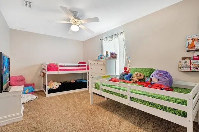 a bedroom with bed and a chandelier