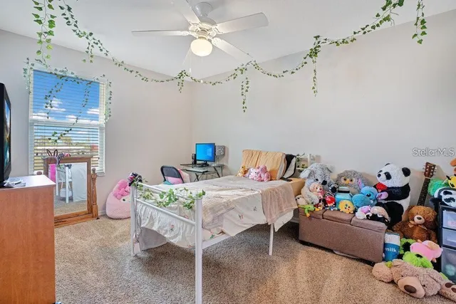 a bedroom with a bed table and window