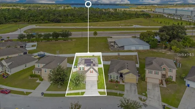 an aerial view of a house with a yard basket ball court and outdoor seating