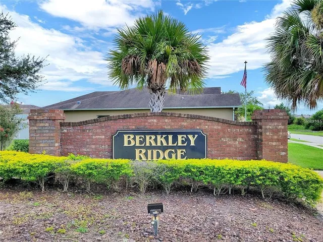 a street sign that is sitting in front of flowers