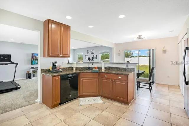 a kitchen with stainless steel appliances granite countertop a stove top oven a sink a counter top space and cabinets