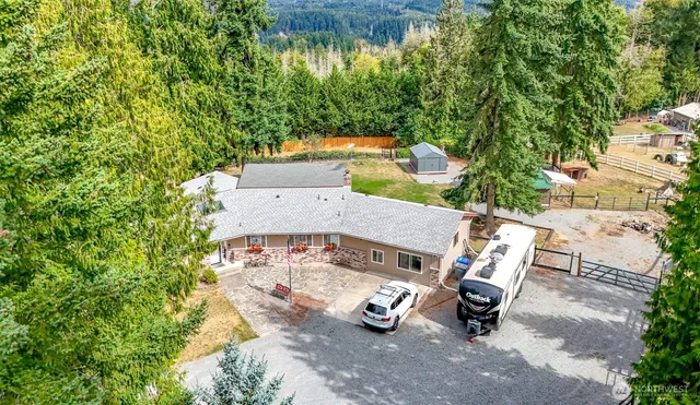 an aerial view of a house with garden space and sitting area