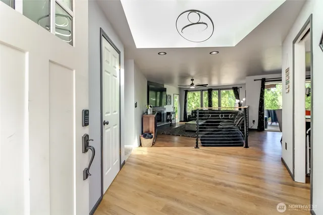 a view of an empty room with glass door and windows