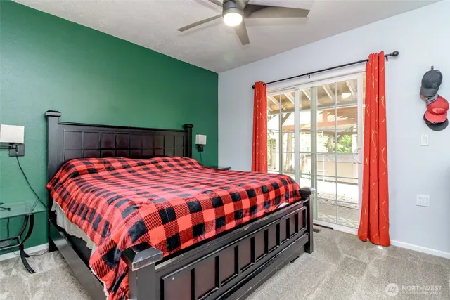 a bedroom with a bed and a lamp on dresser