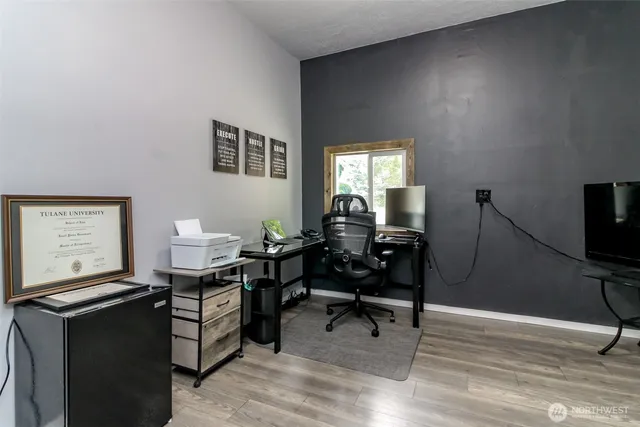 a bedroom with a bed a dresser and a window