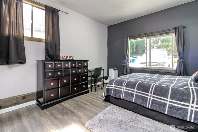 a sitting area with furniture and wooden floor