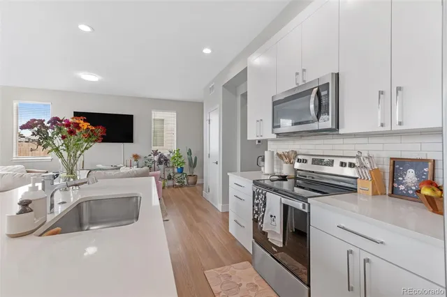 a kitchen with a sink stove and microwave