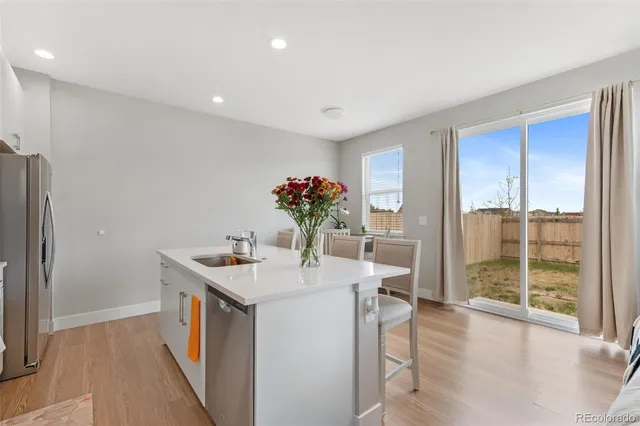 a kitchen with a sink and refrigerator
