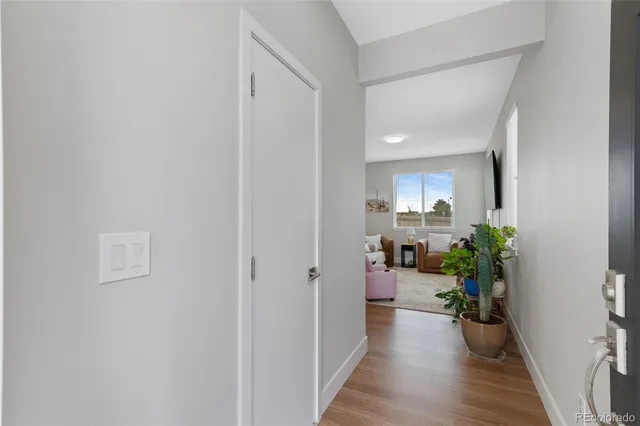 a view of a hallway with dining table and chairs
