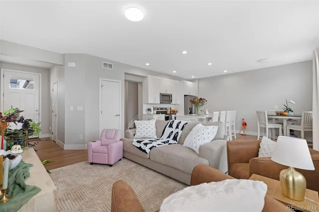 a living room with furniture and a potted plant
