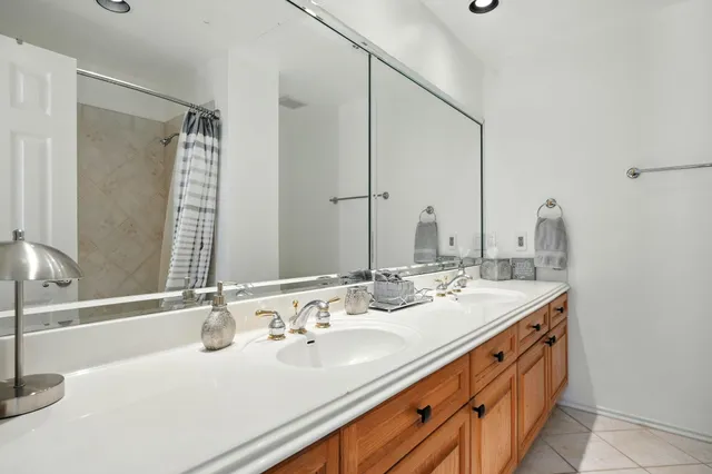 a bathroom with a double vanity sink and a mirror