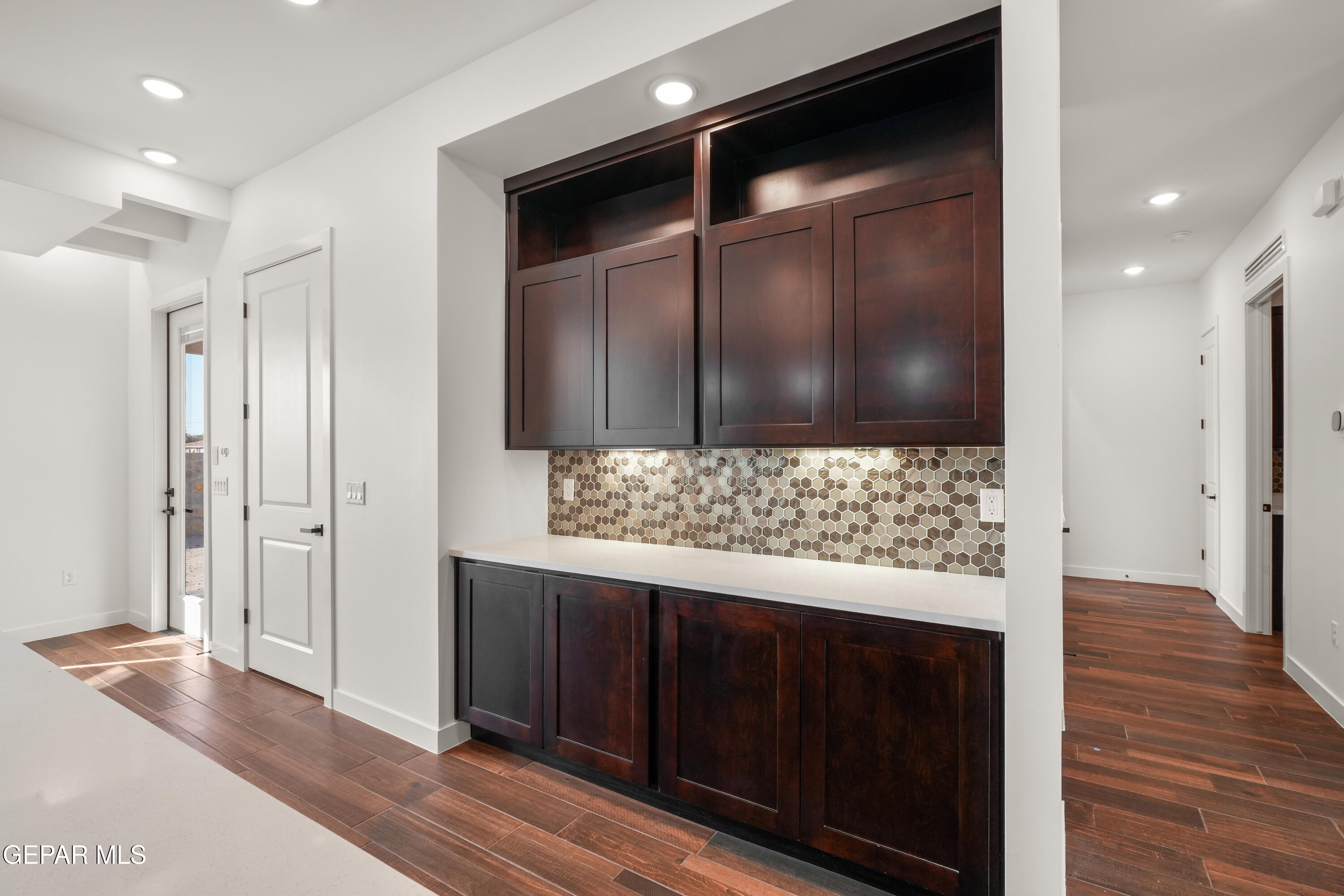 5953 Ruidoso Downs Street El Paso, TX 79932 - Photo 13 of 56 a view of a hallway with wooden floor and cabinets