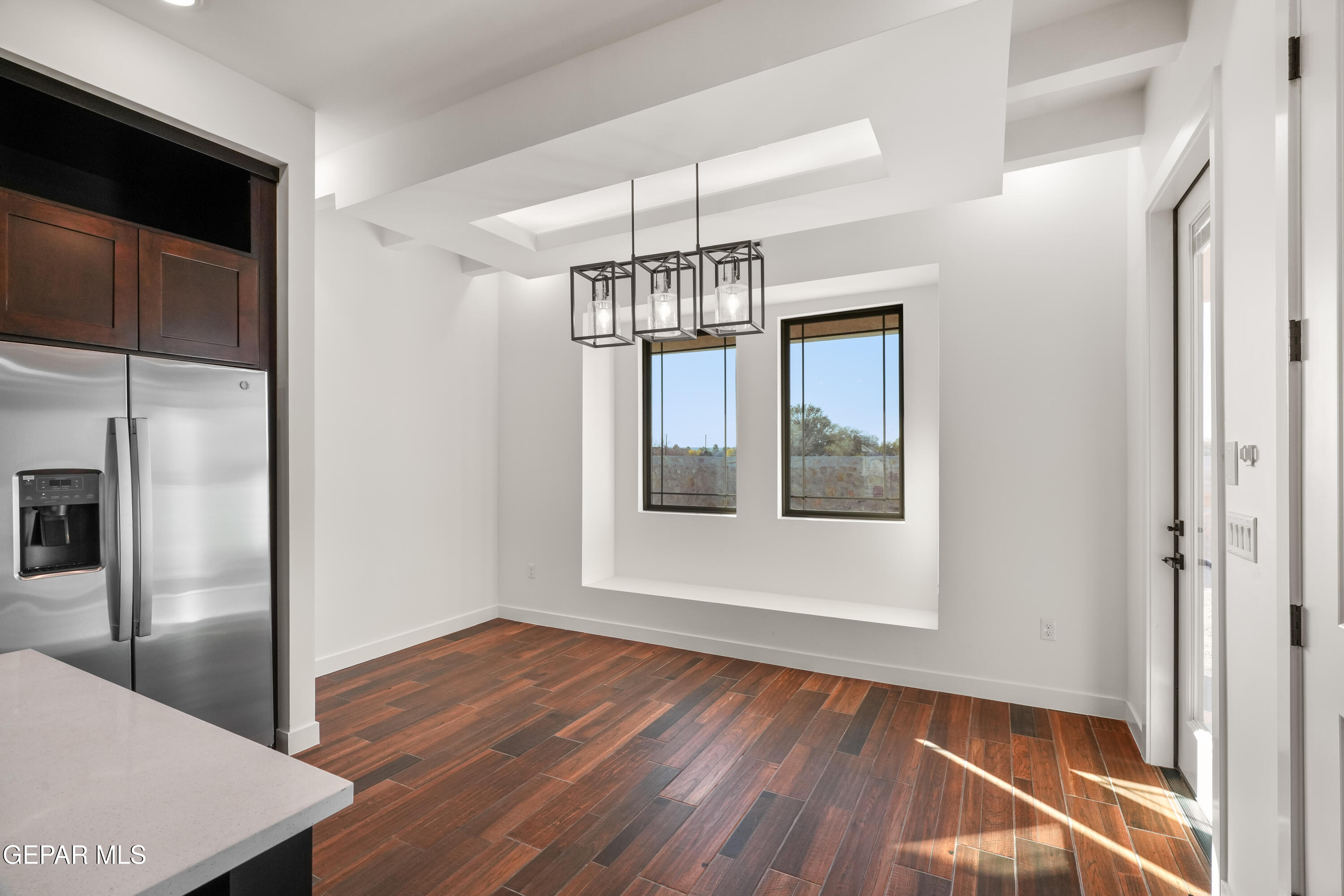 5953 Ruidoso Downs Street El Paso, TX 79932 - Photo 14 of 56 a view of a hallway with wooden floor and chandelier