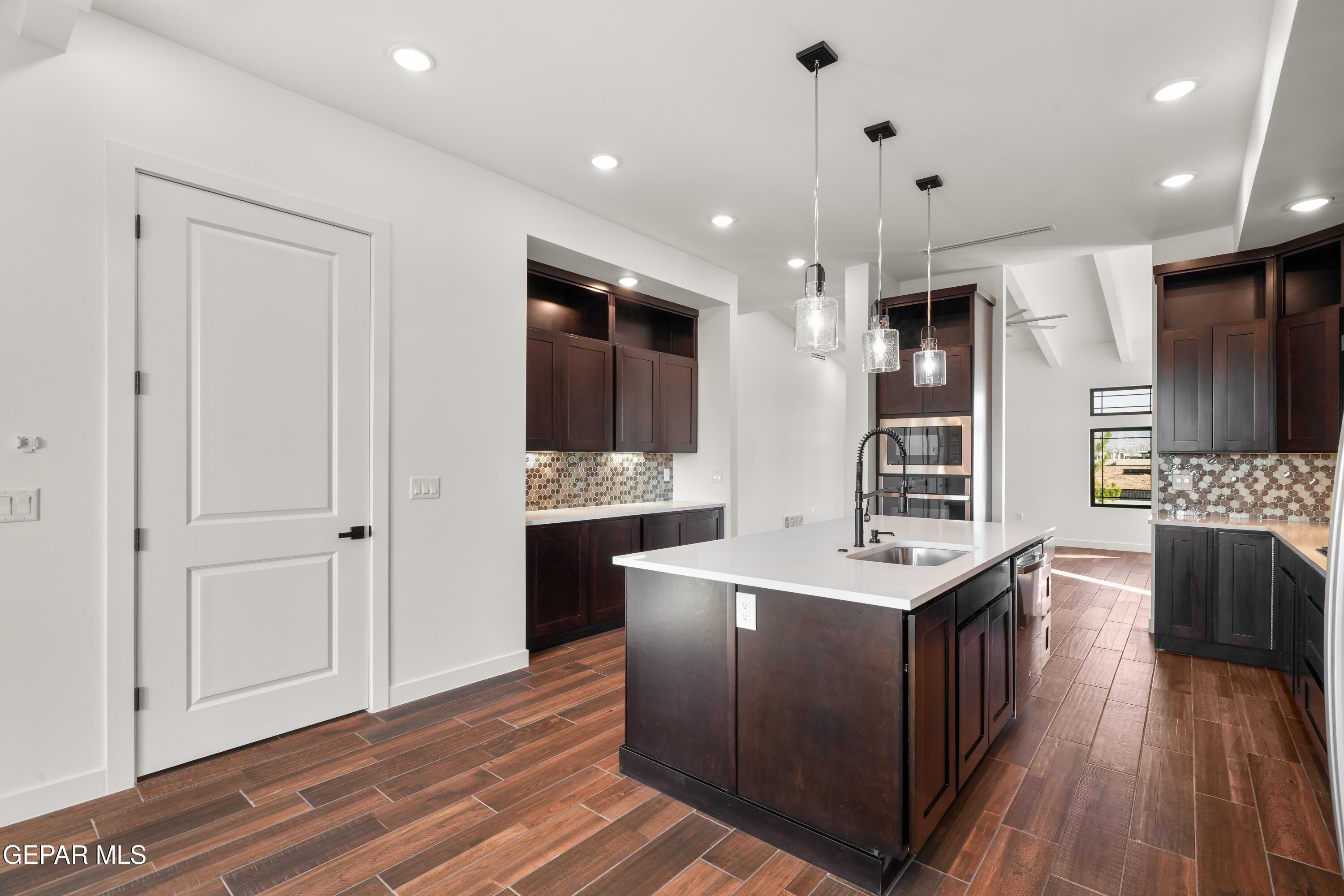 5953 Ruidoso Downs Street El Paso, TX 79932 - Photo 16 of 56 a kitchen with stainless steel appliances granite countertop a stove and a sink