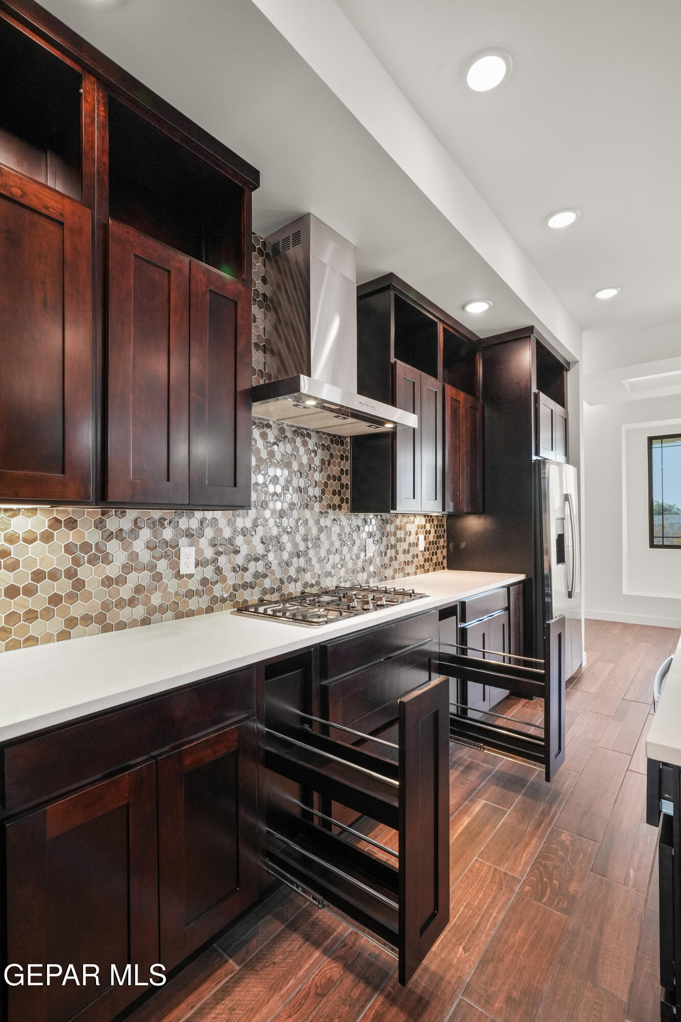 5953 Ruidoso Downs Street El Paso, TX 79932 - Photo 18 of 56 a kitchen with stainless steel appliances wooden cabinets and a counter top space