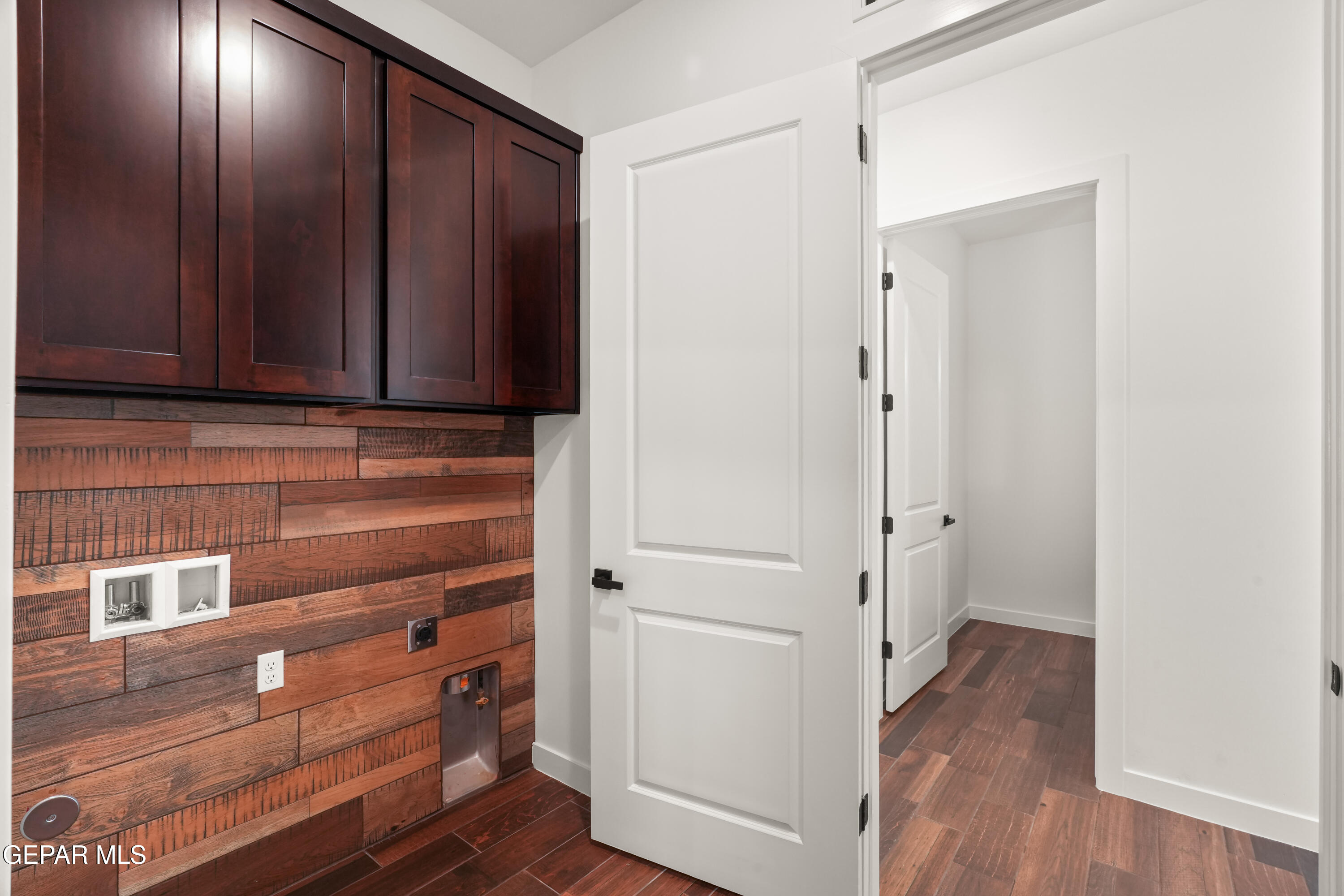 5953 Ruidoso Downs Street El Paso, TX 79932 - Photo 27 of 56 a view of storage and utility room with wooden floor