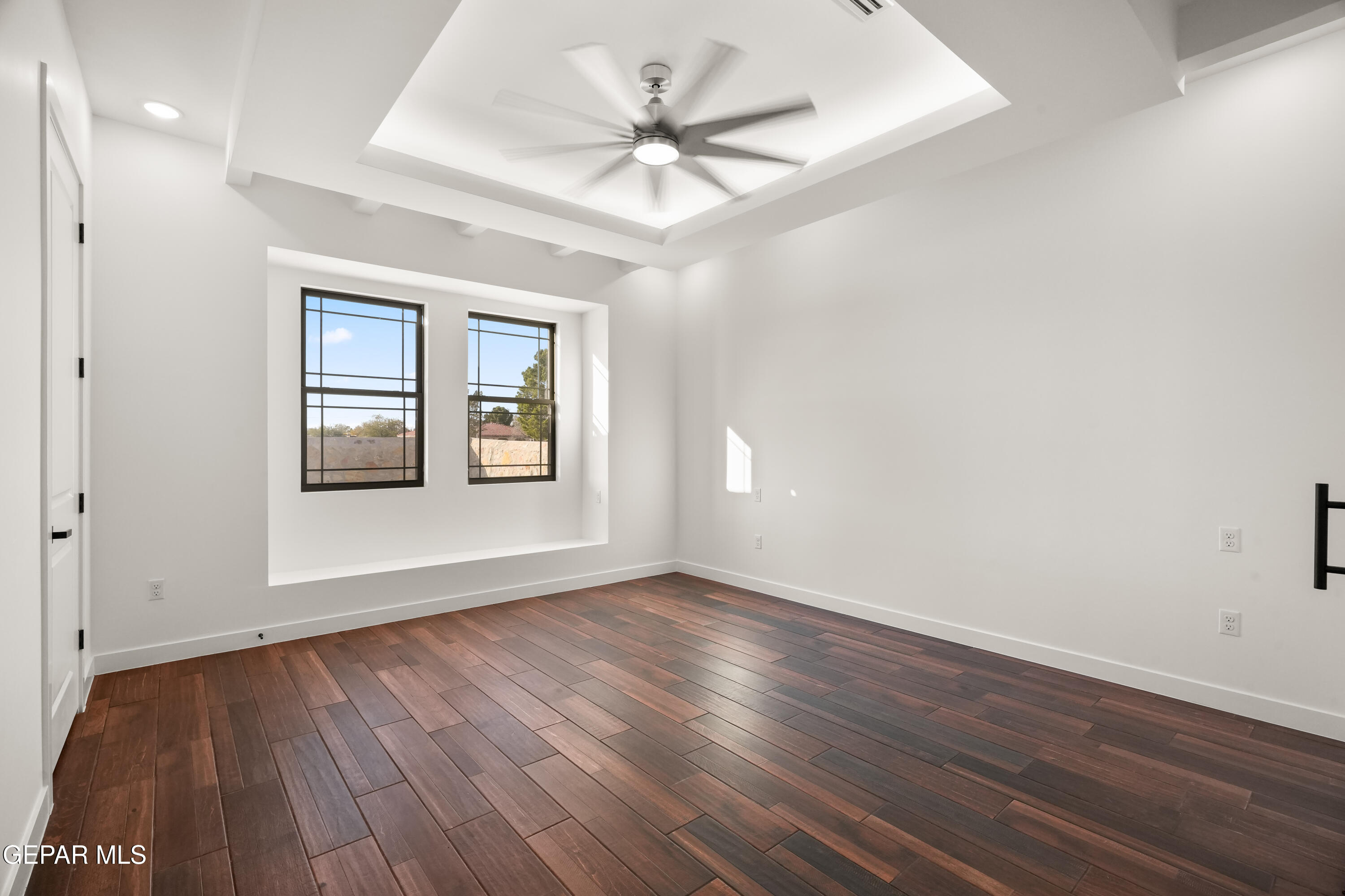 5953 Ruidoso Downs Street El Paso, TX 79932 - Photo 29 of 56 a view of an empty room with window and wooden floor