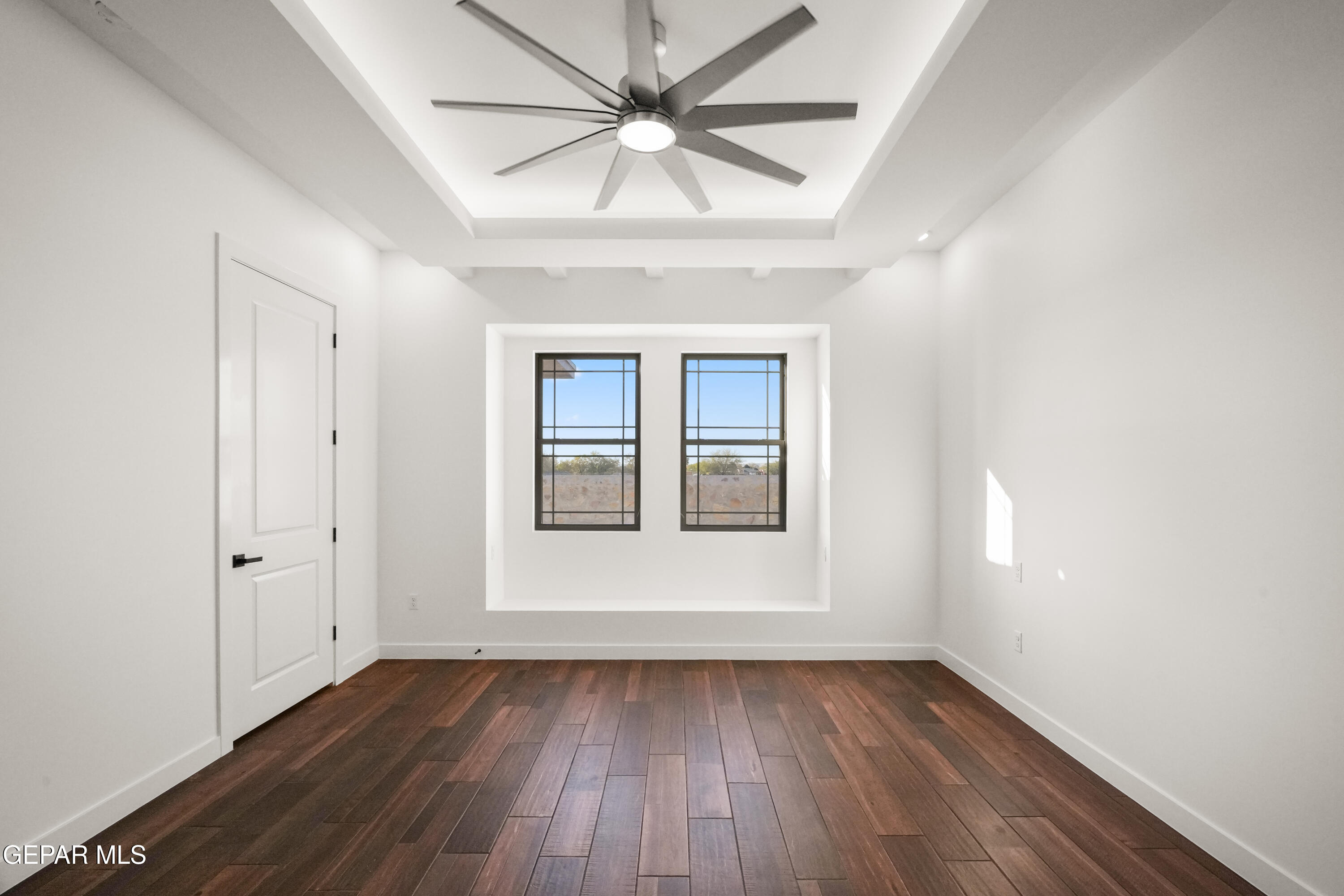 5953 Ruidoso Downs Street El Paso, TX 79932 - Photo 31 of 56 wooden floor in an empty room with a window