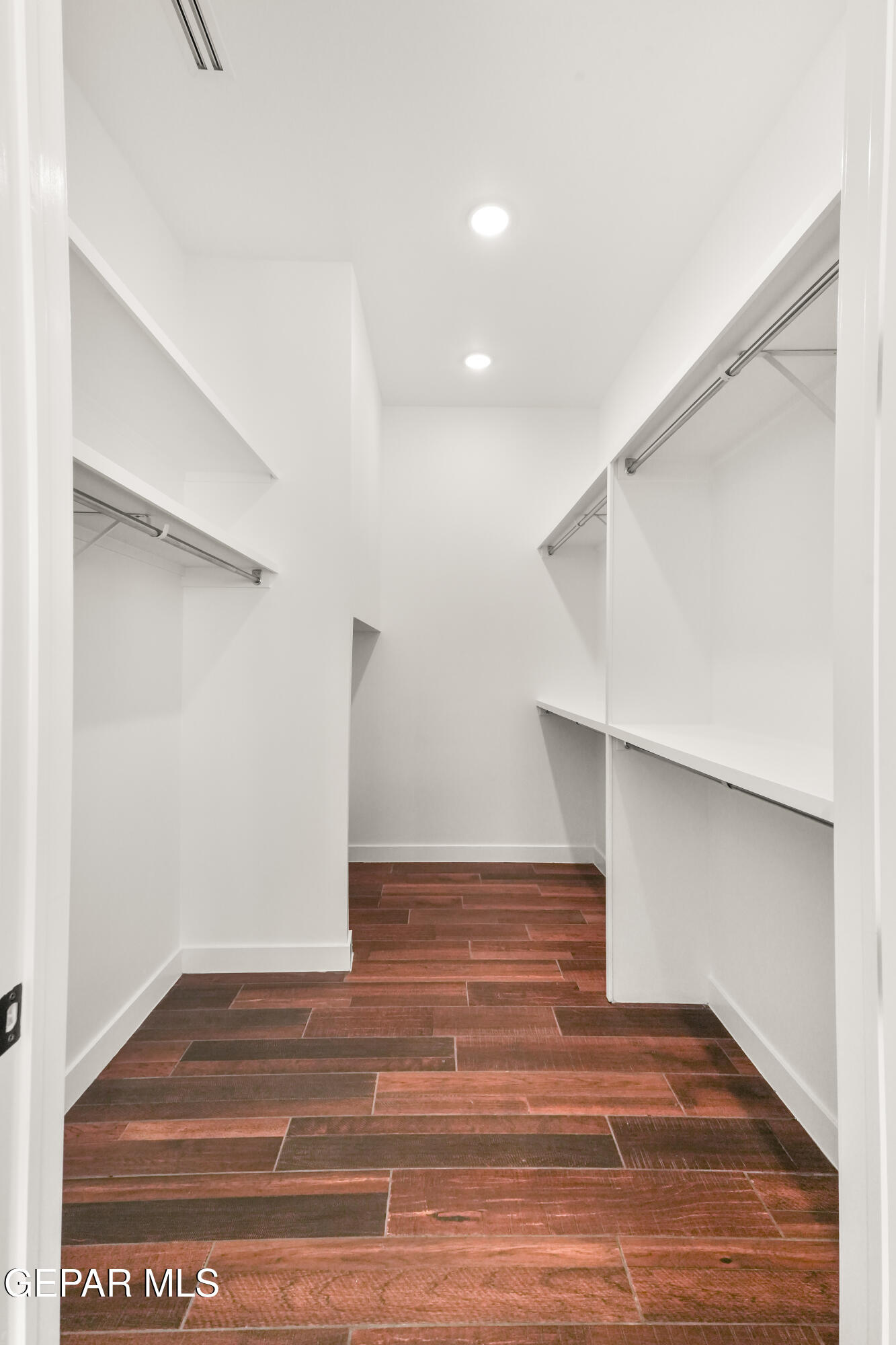 5953 Ruidoso Downs Street El Paso, TX 79932 - Photo 32 of 56 a view of an empty room with wooden floor and closet