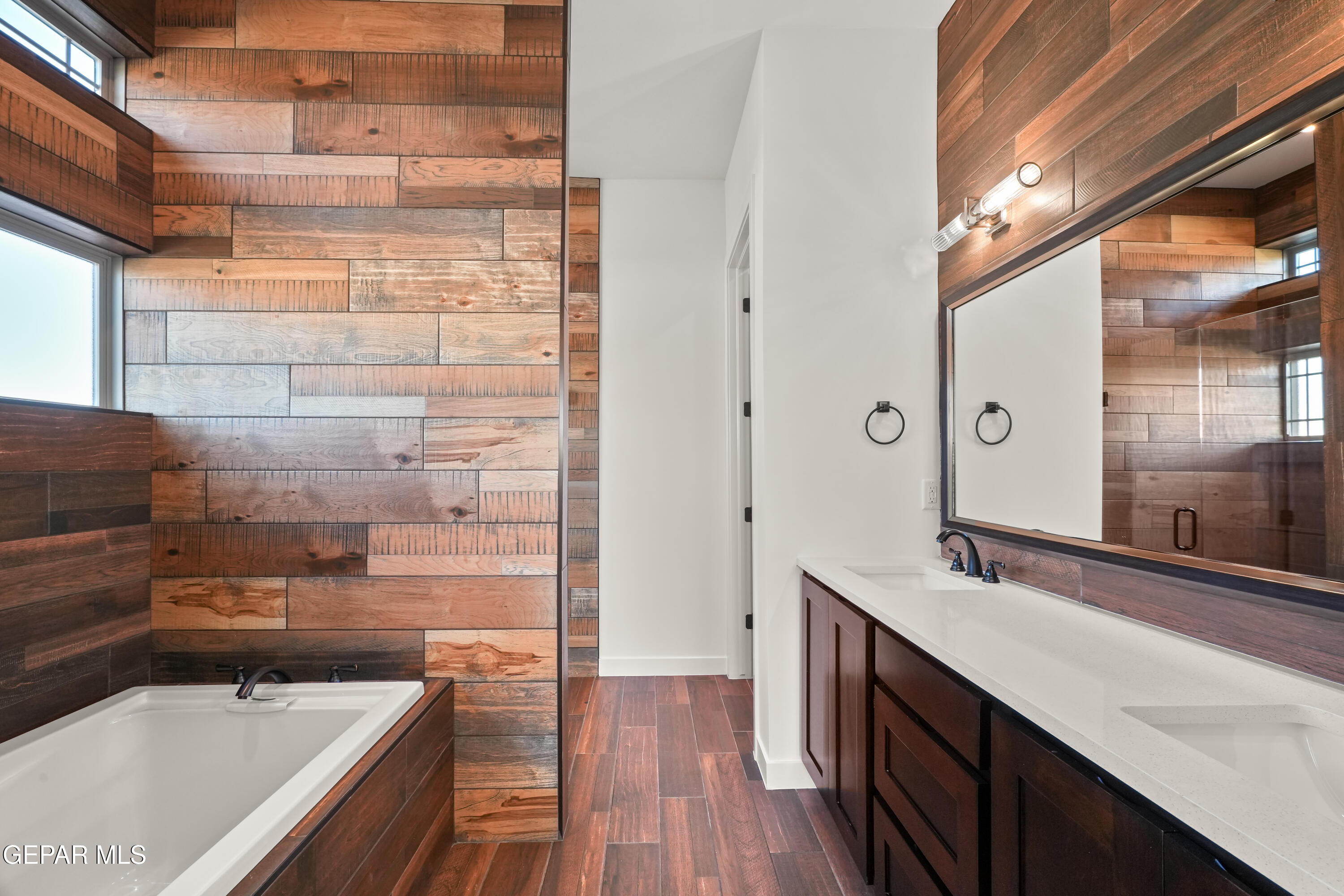 5953 Ruidoso Downs Street El Paso, TX 79932 - Photo 33 of 56 a bathroom with a sink and a large mirror