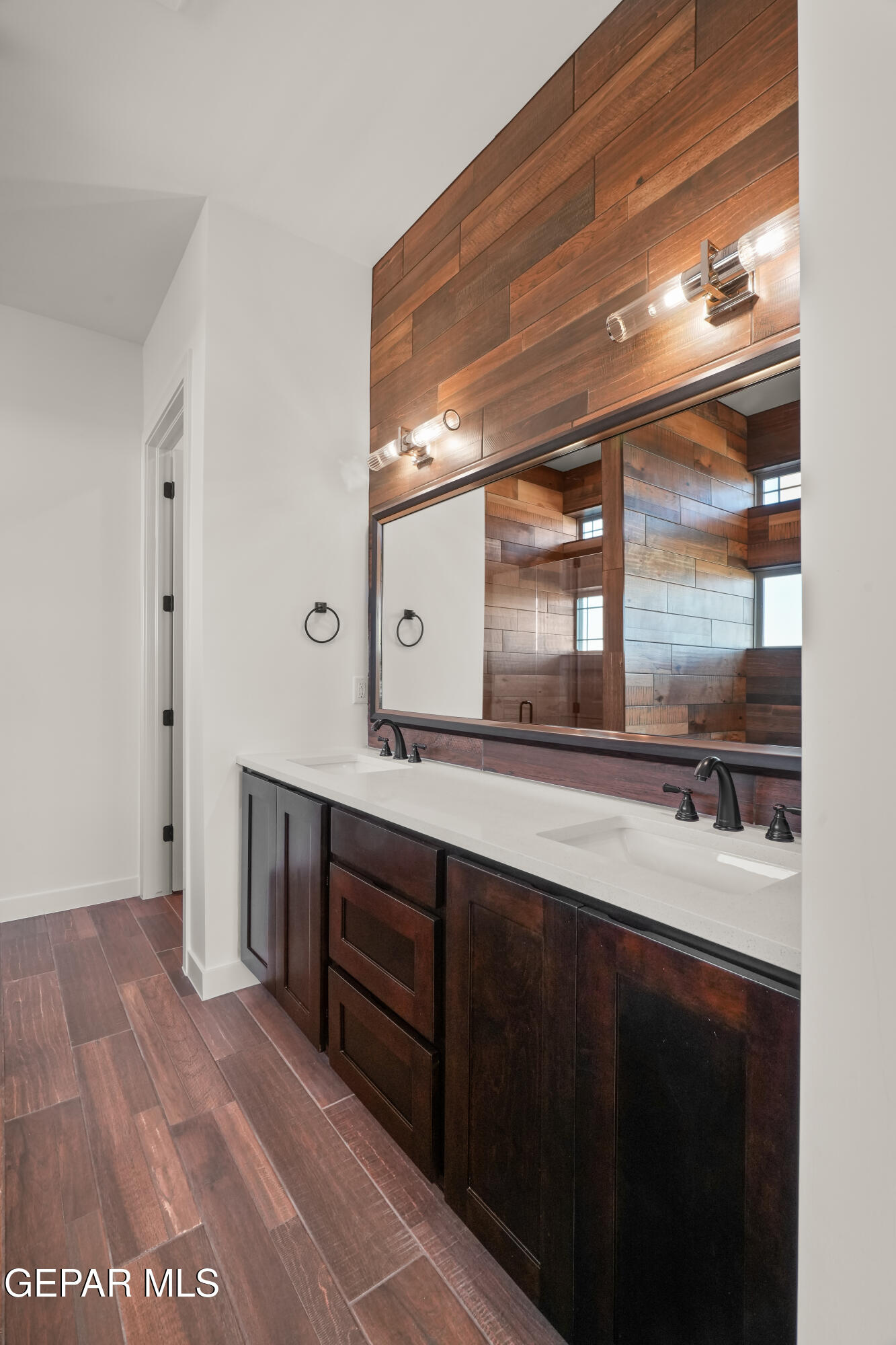 5953 Ruidoso Downs Street El Paso, TX 79932 - Photo 35 of 56 a spacious bathroom with a double vanity sink and a large mirror