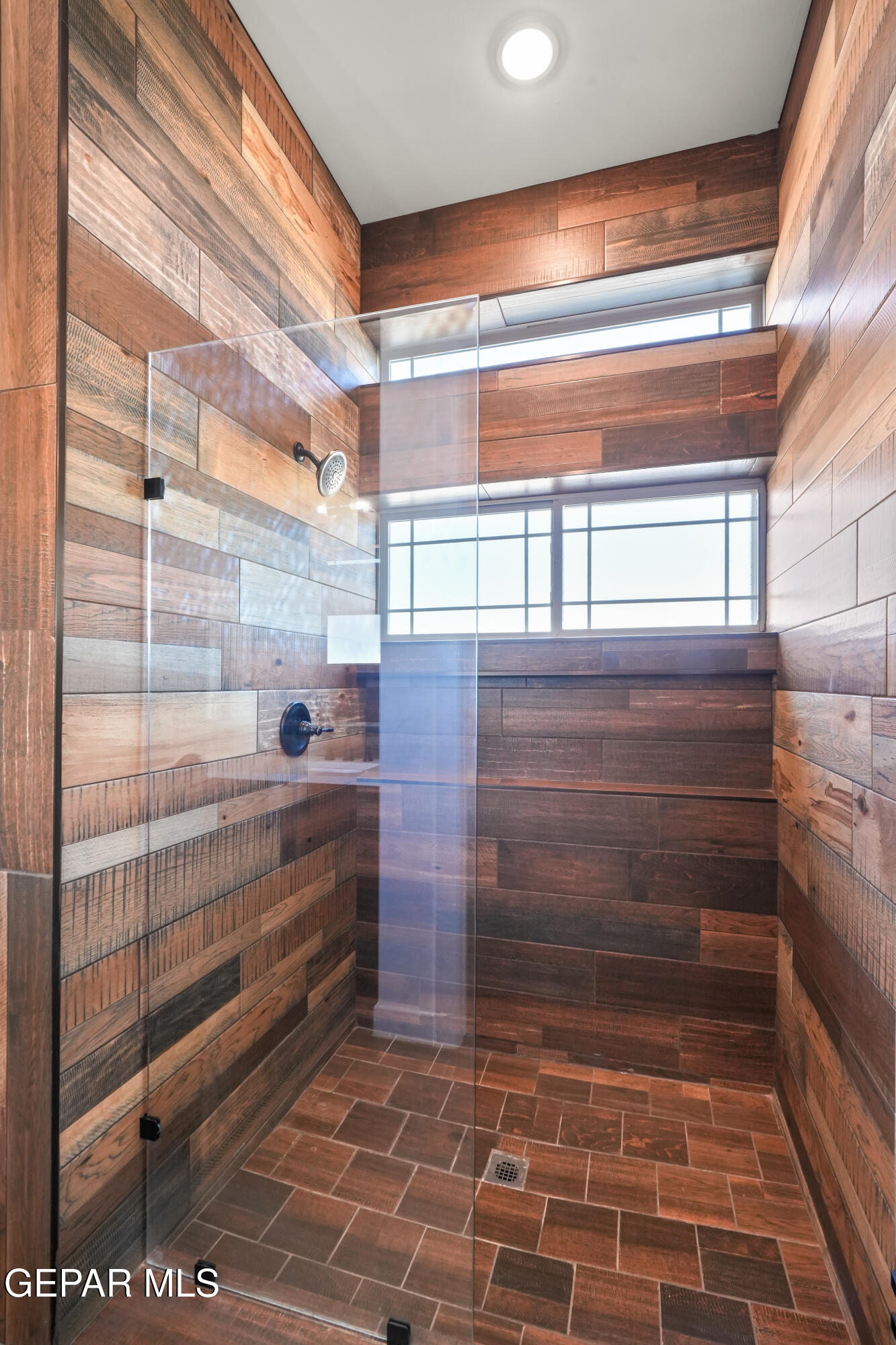 5953 Ruidoso Downs Street El Paso, TX 79932 - Photo 36 of 56 a bathroom with a glass door shower and a sink