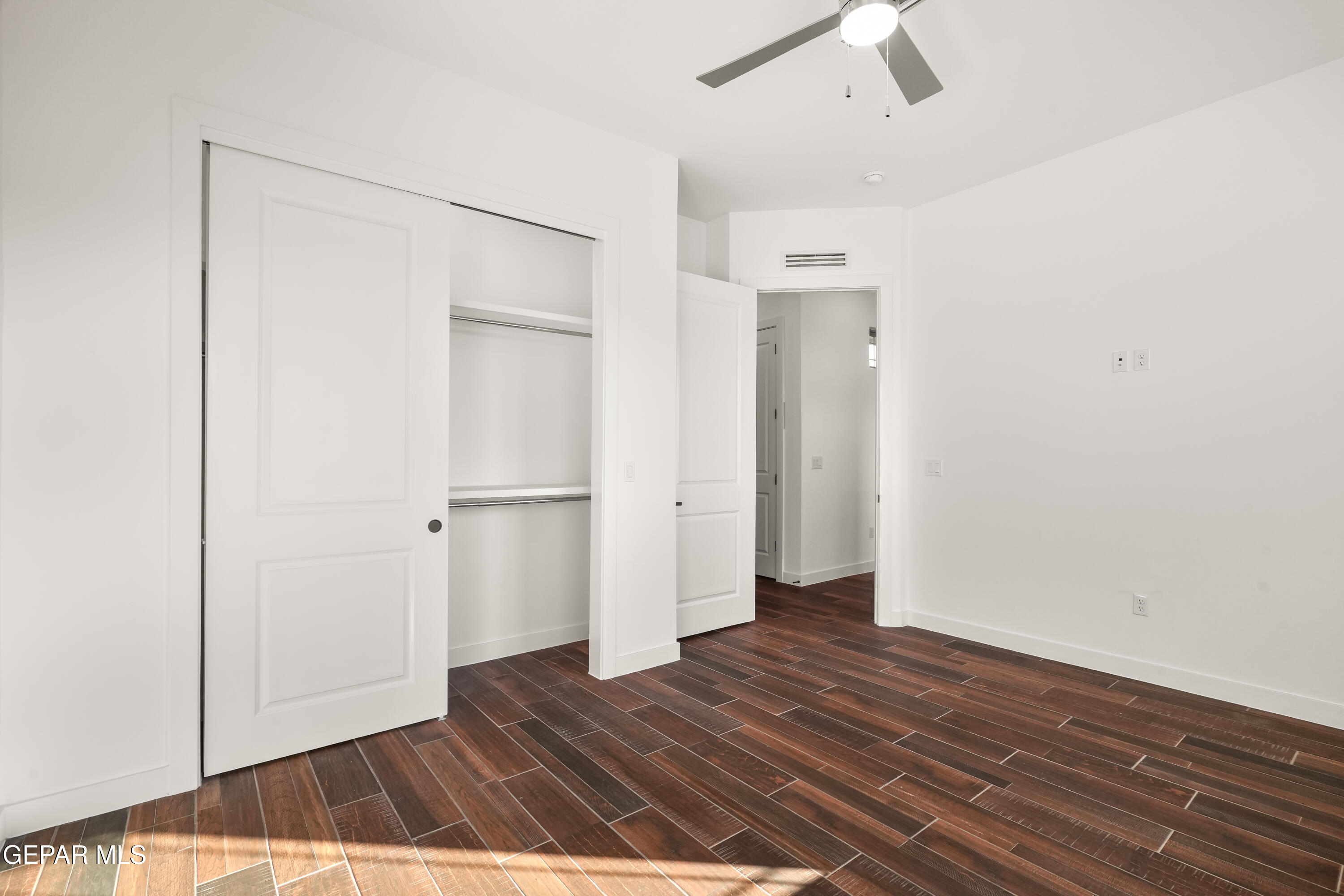 5953 Ruidoso Downs Street El Paso, TX 79932 - Photo 39 of 56 a view of an empty room with wooden floor