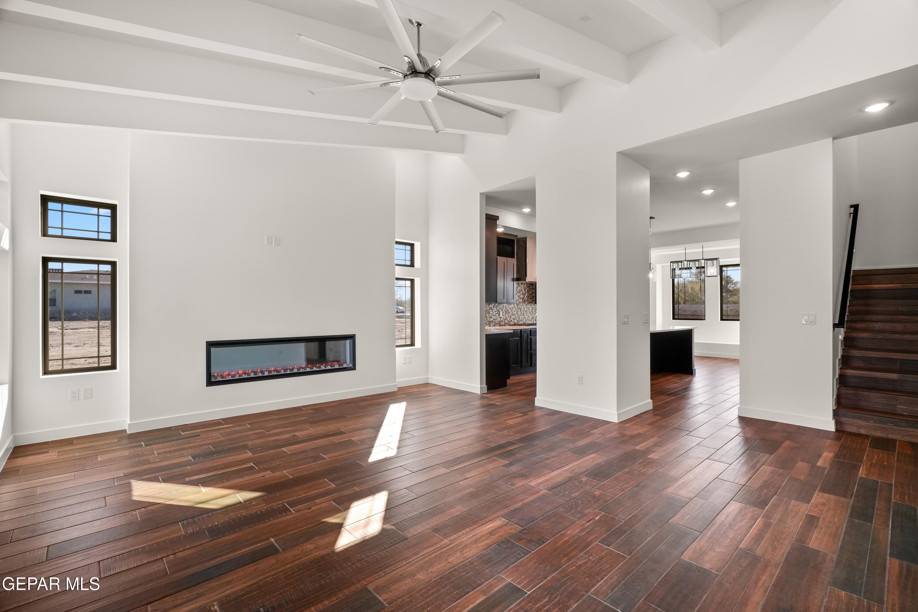 5953 Ruidoso Downs Street El Paso, TX 79932 - Photo 5 of 56 a view of a livingroom with wooden floor and a kitchen space