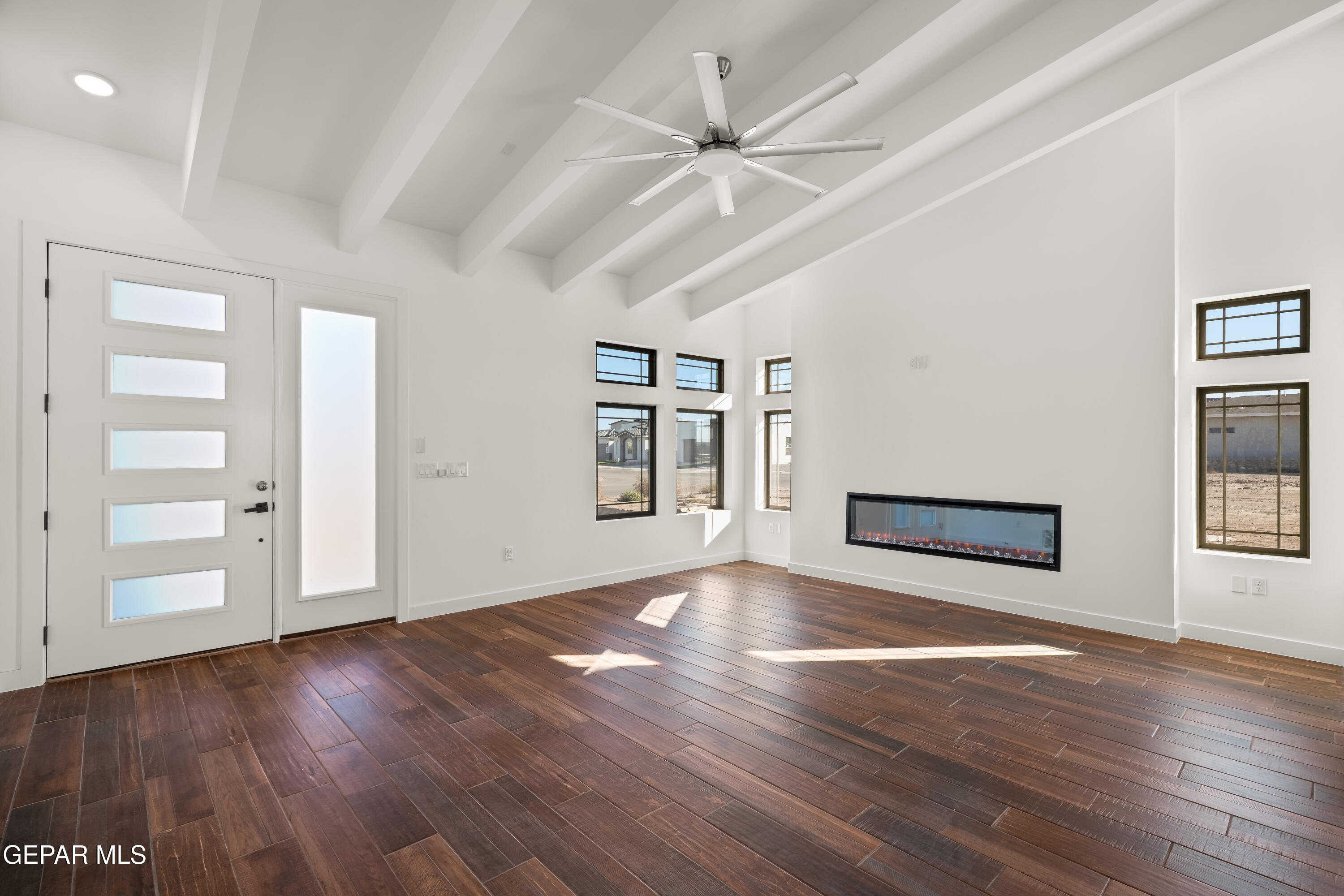 5953 Ruidoso Downs Street El Paso, TX 79932 - Photo 7 of 56 a view of an empty room with wooden floor and a window