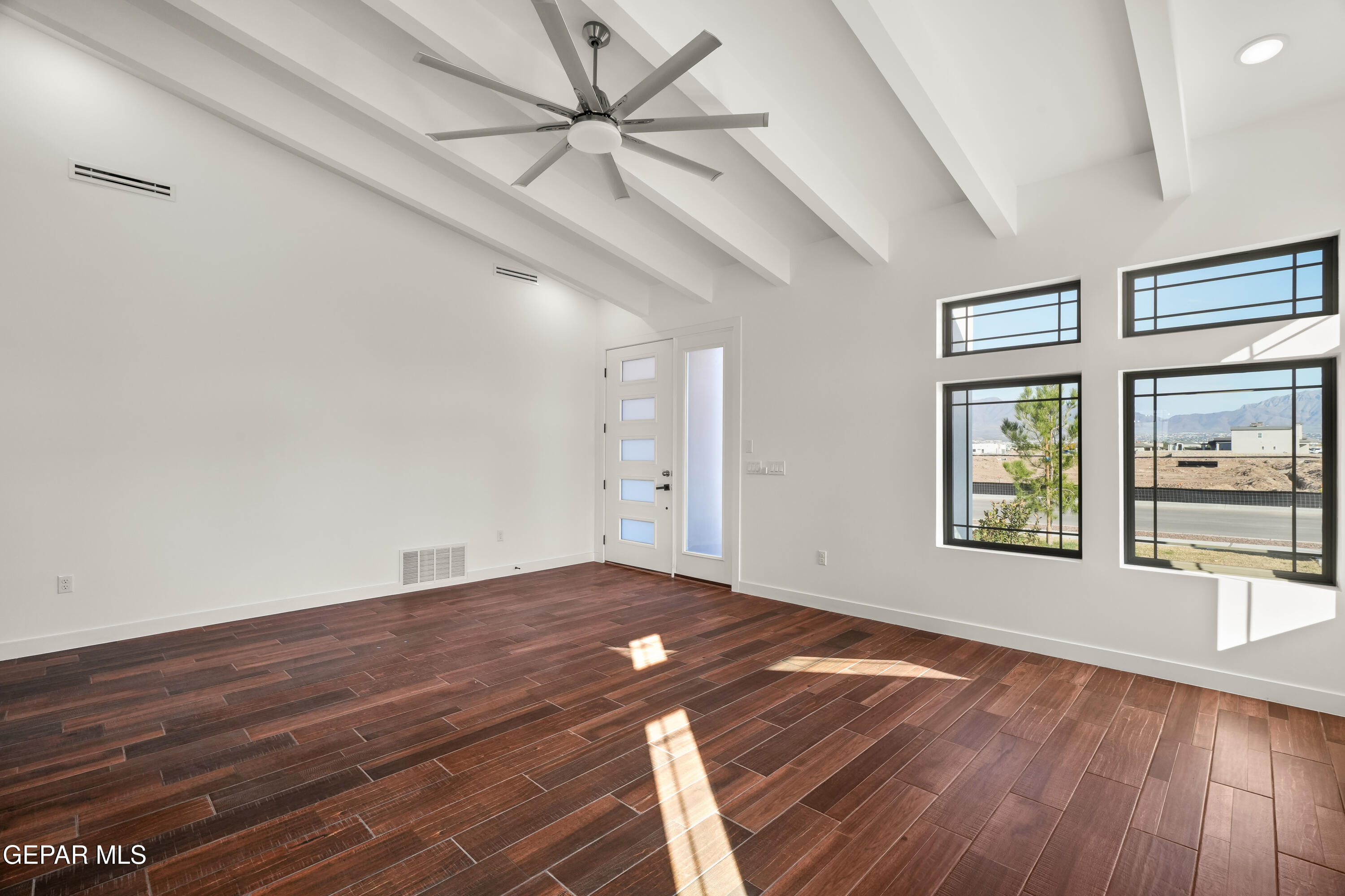 5953 Ruidoso Downs Street El Paso, TX 79932 - Photo 9 of 56 wooden floor in an empty room with a window